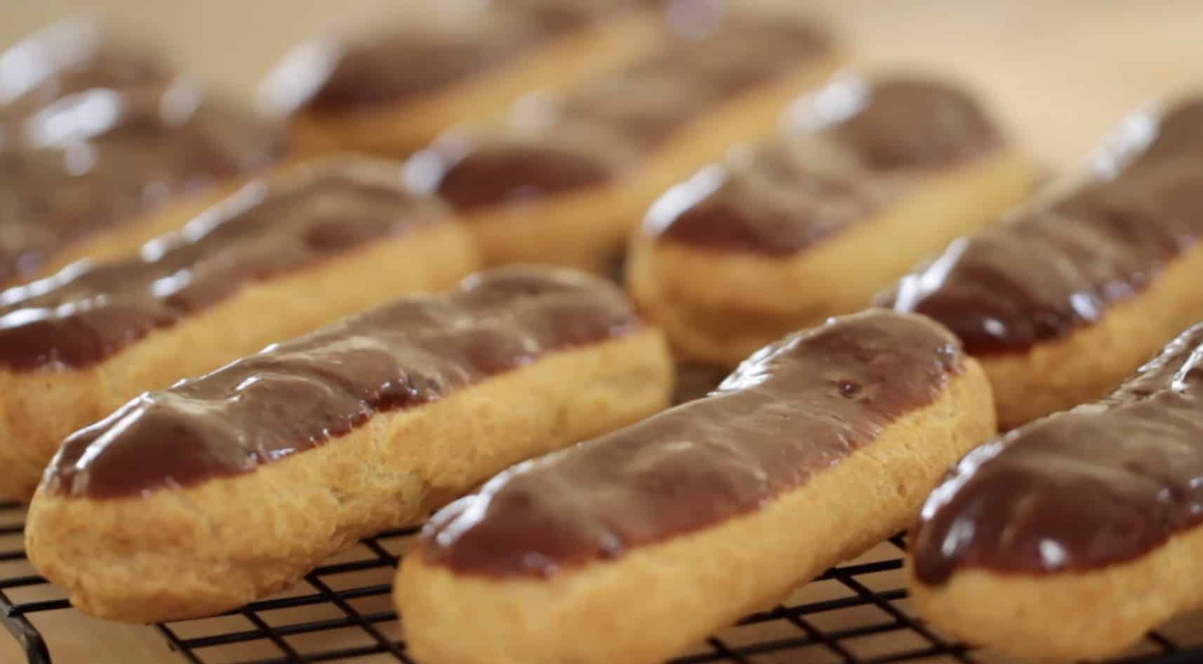 Chocolate eclairs on a cooling rack cooling