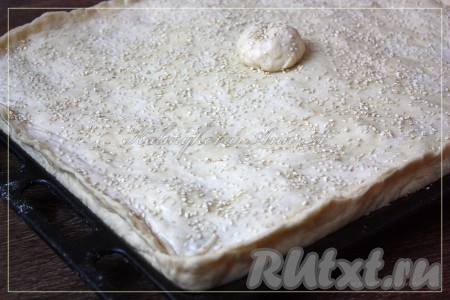 Смазать пирог молоком, посыпать кунжутом. Выпекать в разогретой духовке примерно 40-55 минут при температуре 180 градусов.
