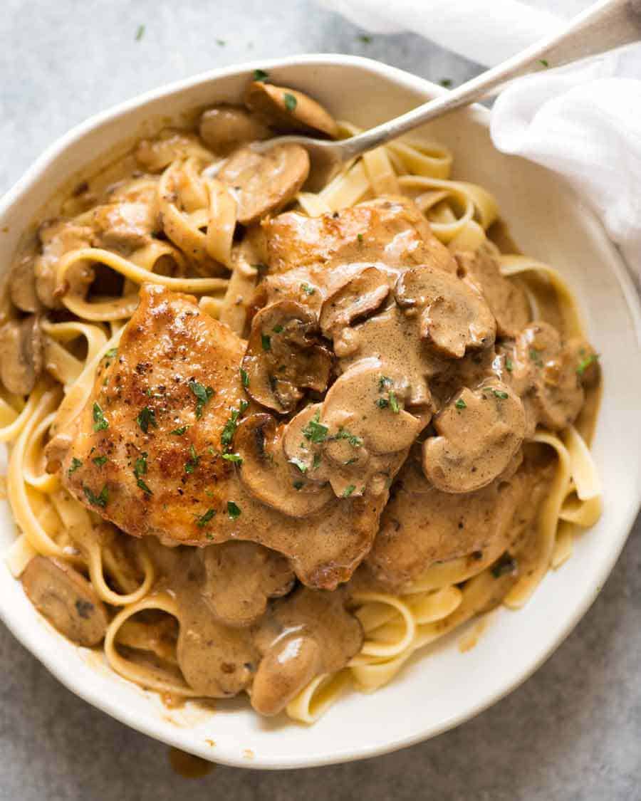 Overhead photo of Chicken Stroganoff in a white bowl, ready to be eaten